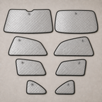 Eight separate custom-shaped full-cabin blackout shade panels