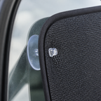 Clear suction-cup mounting detail on a bound blackout panel