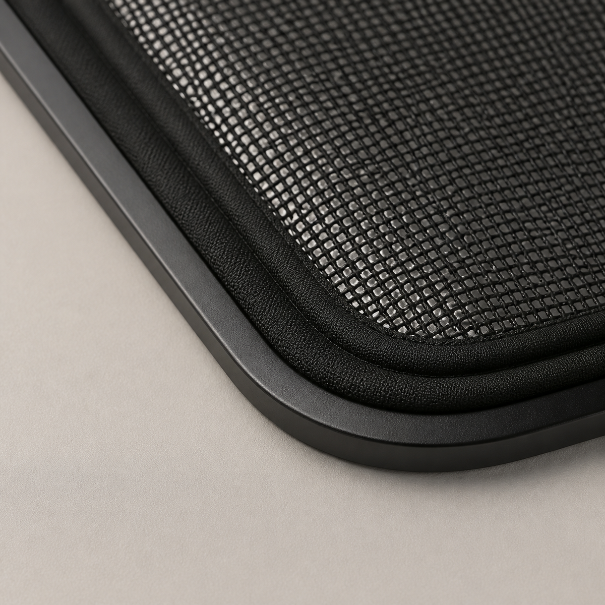 Macro detail of breathable black mesh and slim alloy magnetic edging