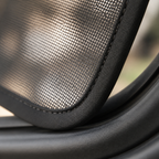 Macro view of fine black mesh and bound perimeter stitching